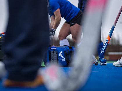 Scottish Hockey During Training with a Physique pitchside bag visble in betwee hockey sticks