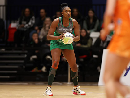 Wales netball player holding the ball during a match